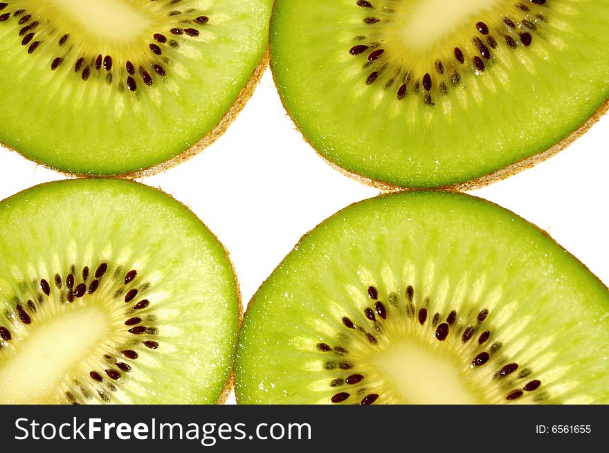Slices ripe а green kiwi on the white background