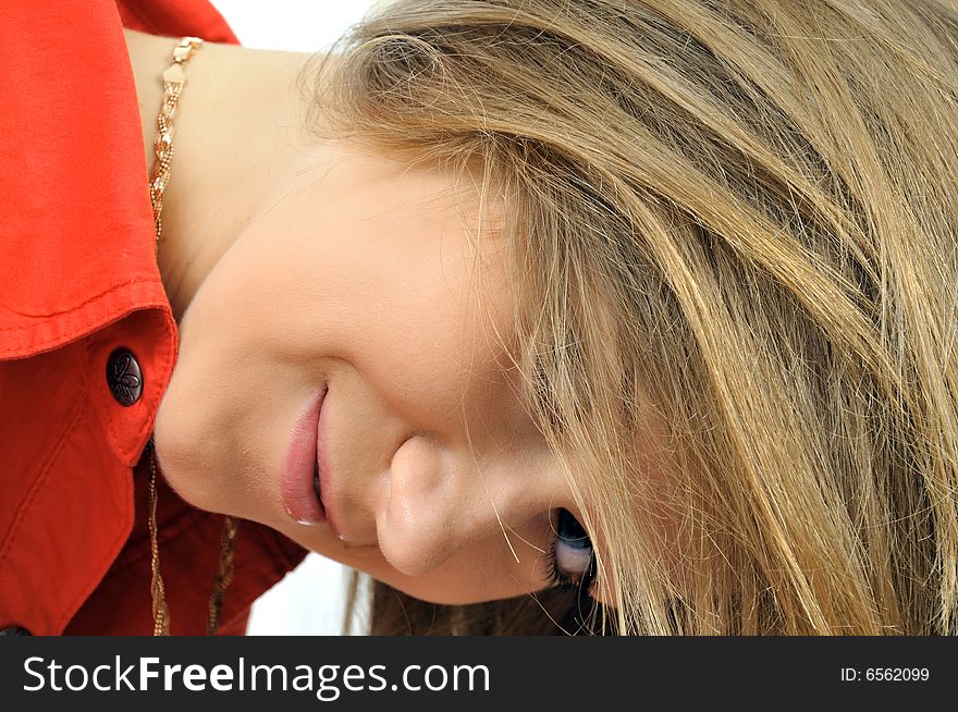 Young smiling girl looking through her hair