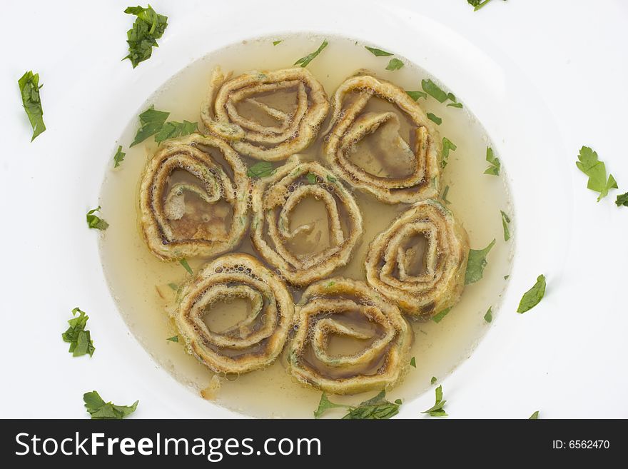 Plate with pan cake soup and parsley