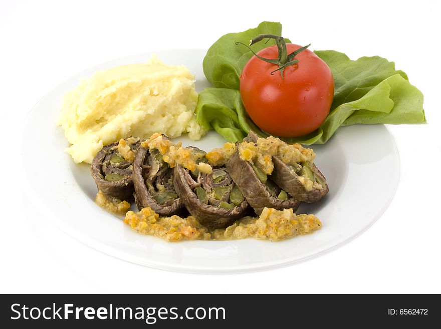 Roulade with mashed potatoes on a white plate