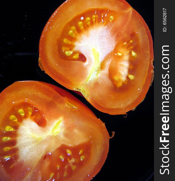 Ripe tomato cut on half top view vertical. Ripe tomato cut on half top view vertical.