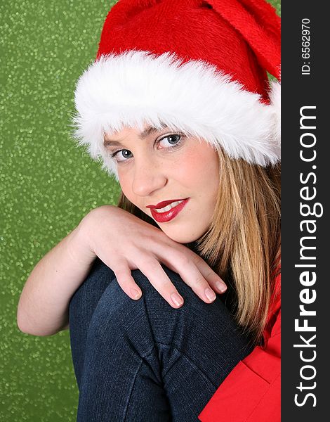 Christmas teen resting on her knee, with a happy smile