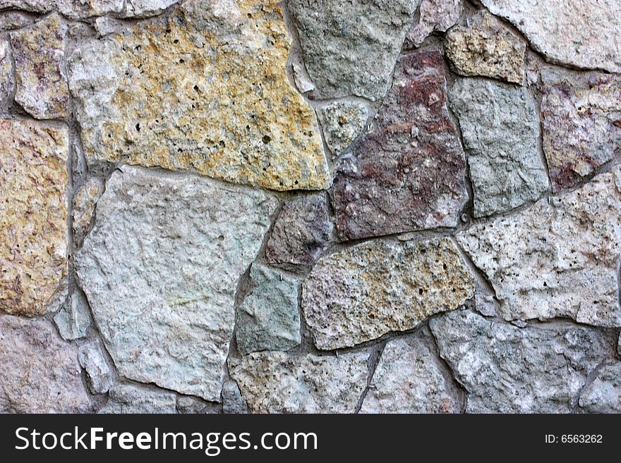 Fragment of brown stone wall