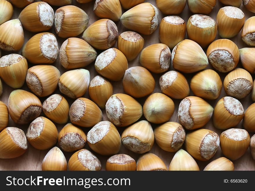 Many of brown nuts on the floor