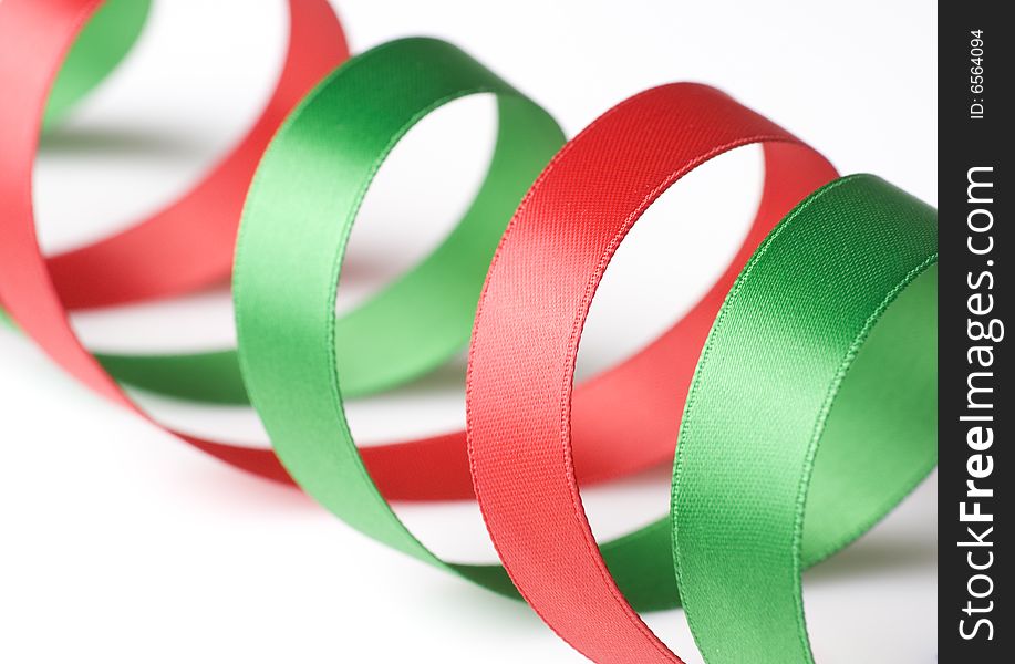 Red and green ribbon curling on white background. Red and green ribbon curling on white background