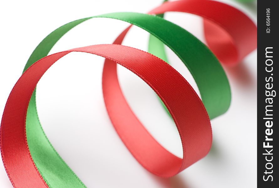 Red and green ribbon curling on white background. Red and green ribbon curling on white background