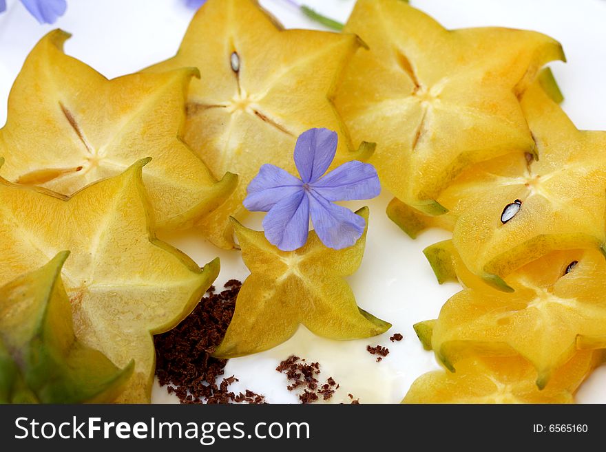 Starfruit decorated with ground chocolate. Starfruit decorated with ground chocolate