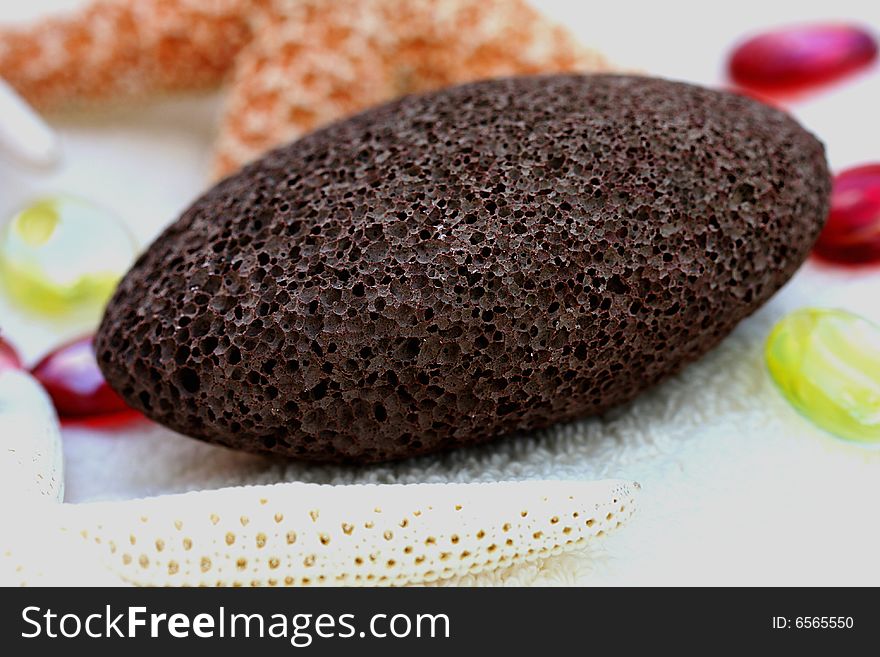 A closeup of spa and massage items (pumice, sponge,towel). A closeup of spa and massage items (pumice, sponge,towel)