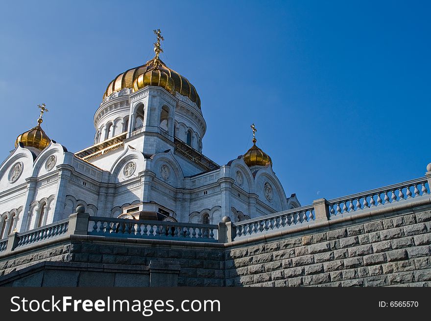 Majestic Temple of the Christ of the Savior under the blue sky with gold domes and crosses on them. Majestic Temple of the Christ of the Savior under the blue sky with gold domes and crosses on them