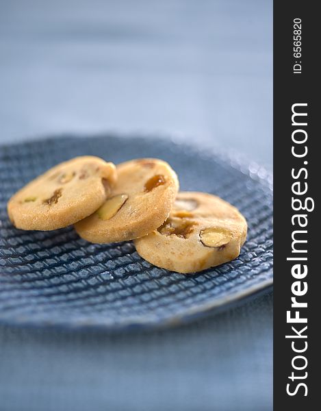 Three homemade cookies on a blue ceramic plate