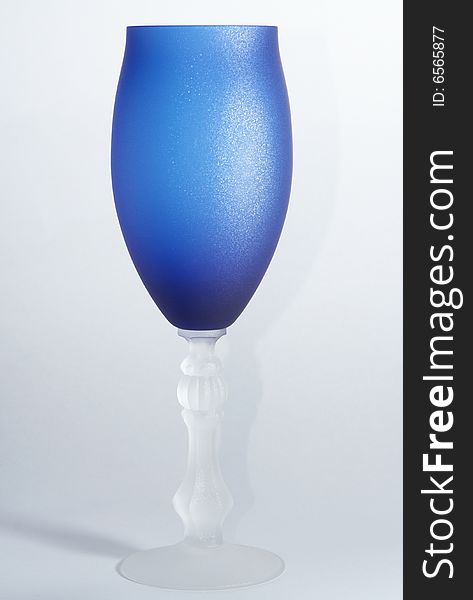 Blue wineglass on the white background