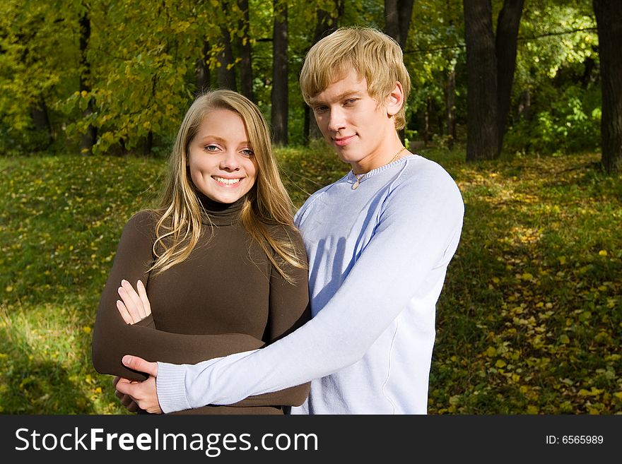 Handsome boy embracing his attractive girlfriend. outdoor