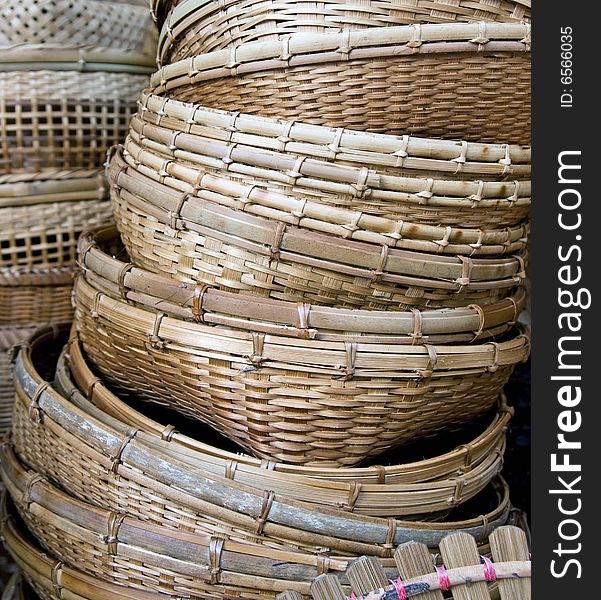 a pile of bamboo baskets close up