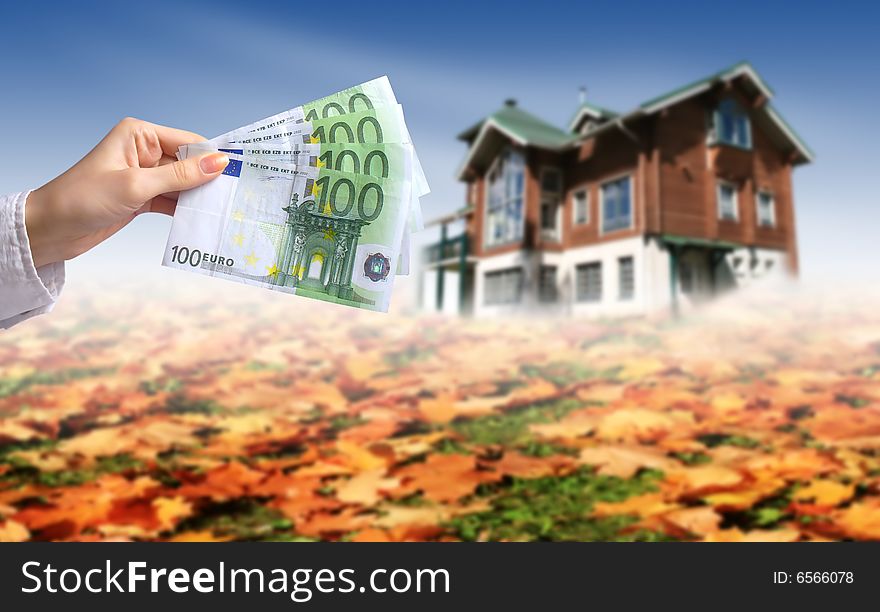 Woman's hands with euro money. House on the background. Buying house concept. Woman's hands with euro money. House on the background. Buying house concept.