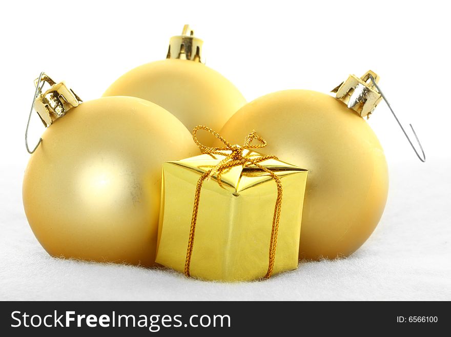 Gold Christmas Ornaments Against White Ground. Gold Christmas Ornaments Against White Ground