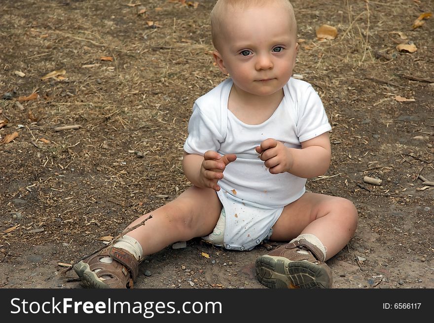 Cute 1 year old baby boy in sitting in park. Cute 1 year old baby boy in sitting in park