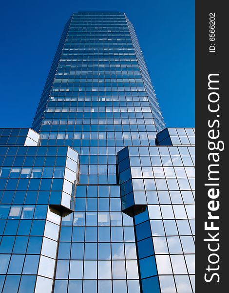 Blue skyscraper on a clear blue sky background