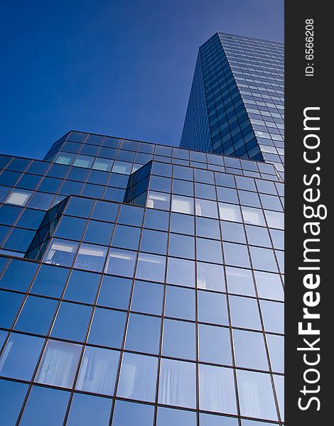 Blue skyscraper on a clear blue sky background