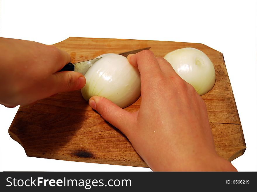 Hands hand cutting onion on a wooden table and white background. cooking activities. Hands hand cutting onion on a wooden table and white background. cooking activities.
