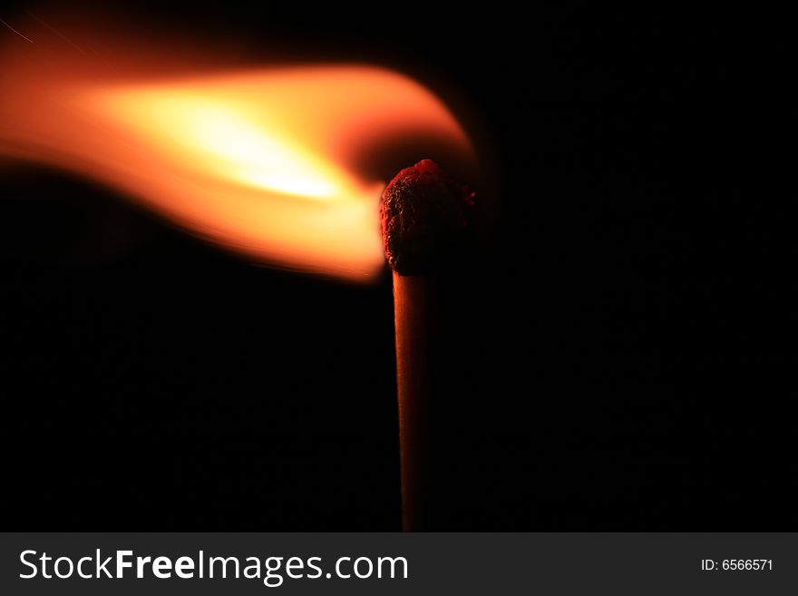 Macro of burning match on black background