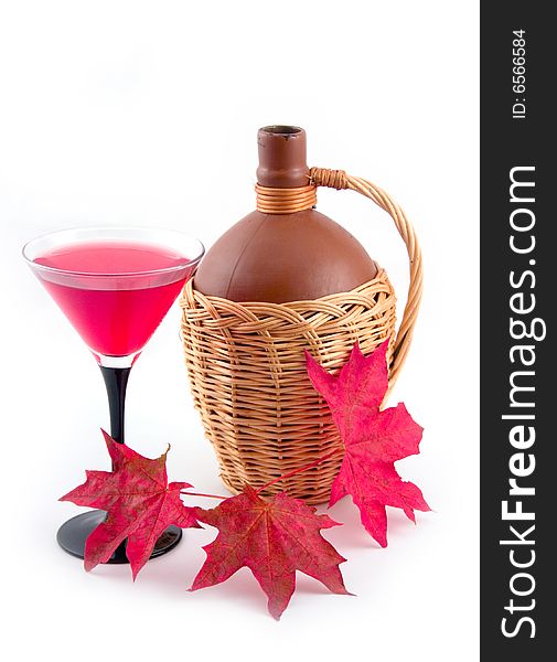Bottle fault in yellow basket and red maple leaves on white background