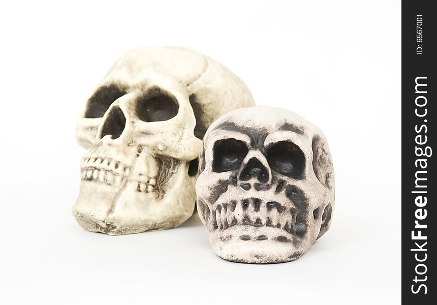 Replicas of two human skulls placed on a white background. Replicas of two human skulls placed on a white background