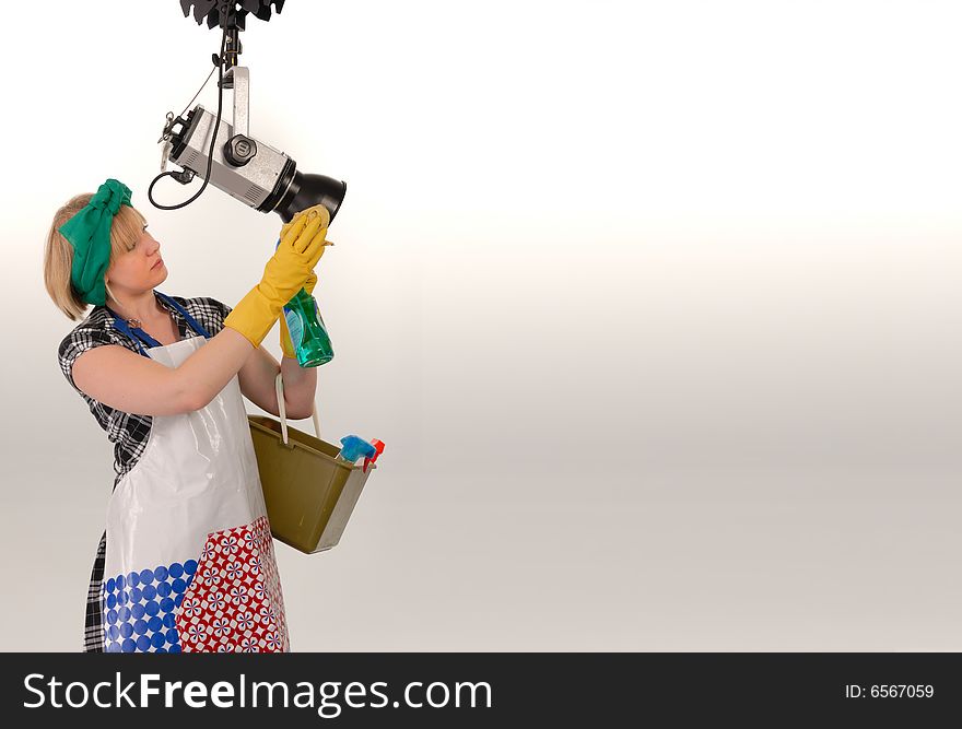 Woman cleaning photo studio with space for rtext, humorous concept