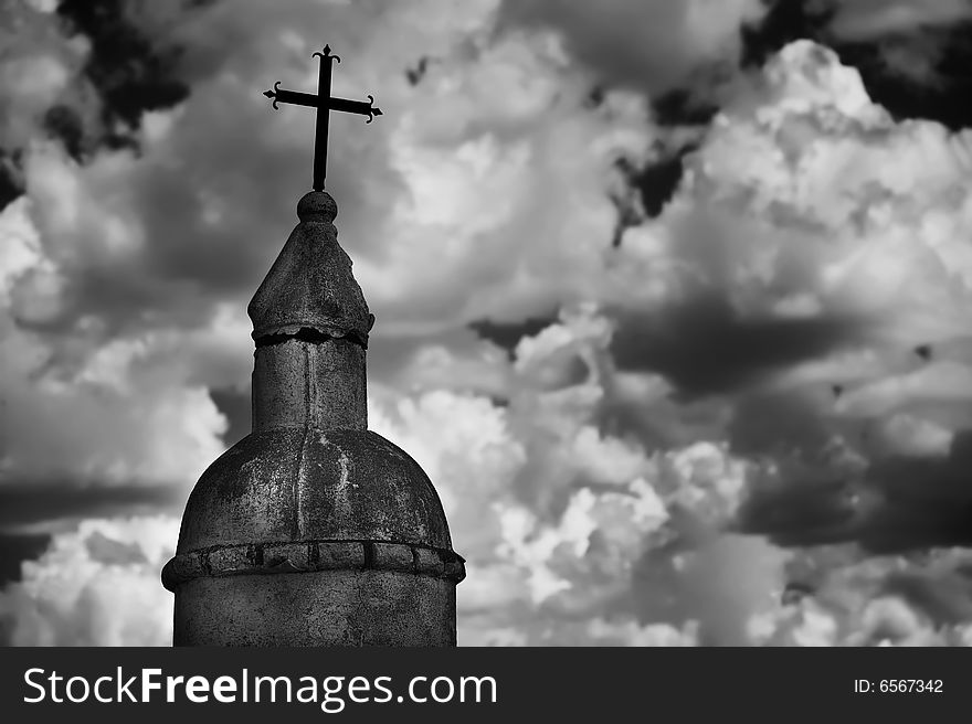 Black and white religious monument against a cloudy sky