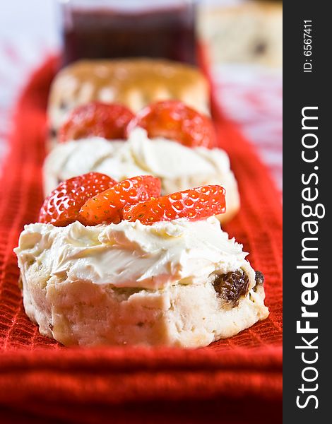 A Line Of Scone Halves With Strawberries