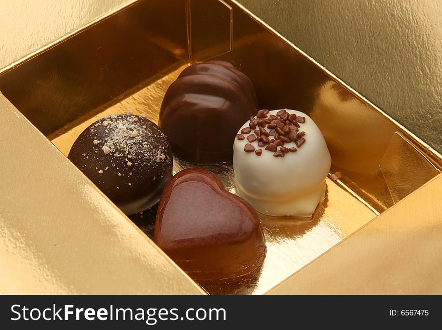 Sweet chocolate pralines in the golden box