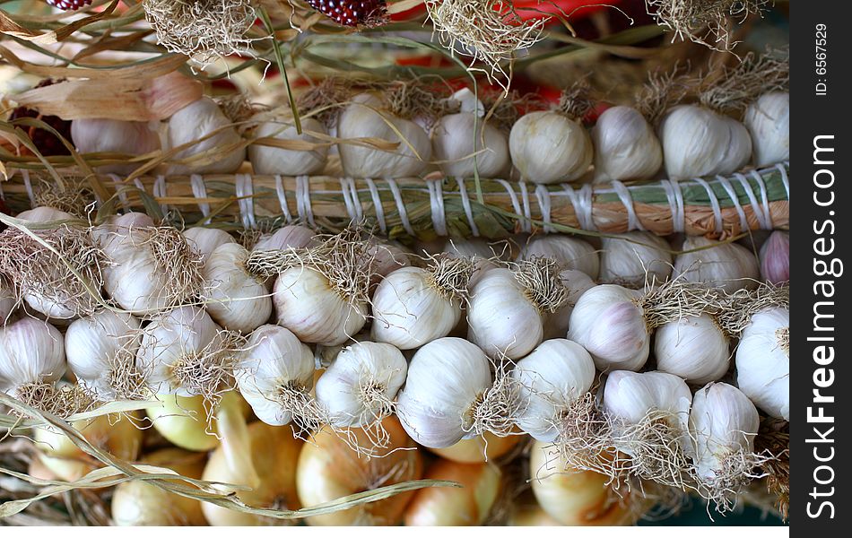 Branches of garlic and onion in the street market. Branches of garlic and onion in the street market