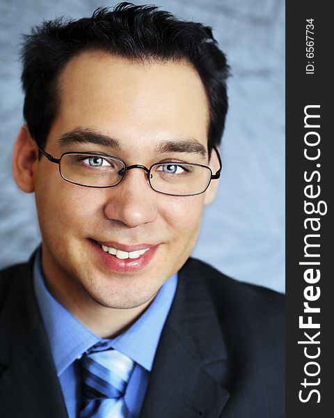 Young business man with glasses, looking smiling at camera. Young business man with glasses, looking smiling at camera