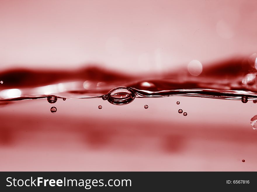 Red water in motion with bubbles, perfect for background