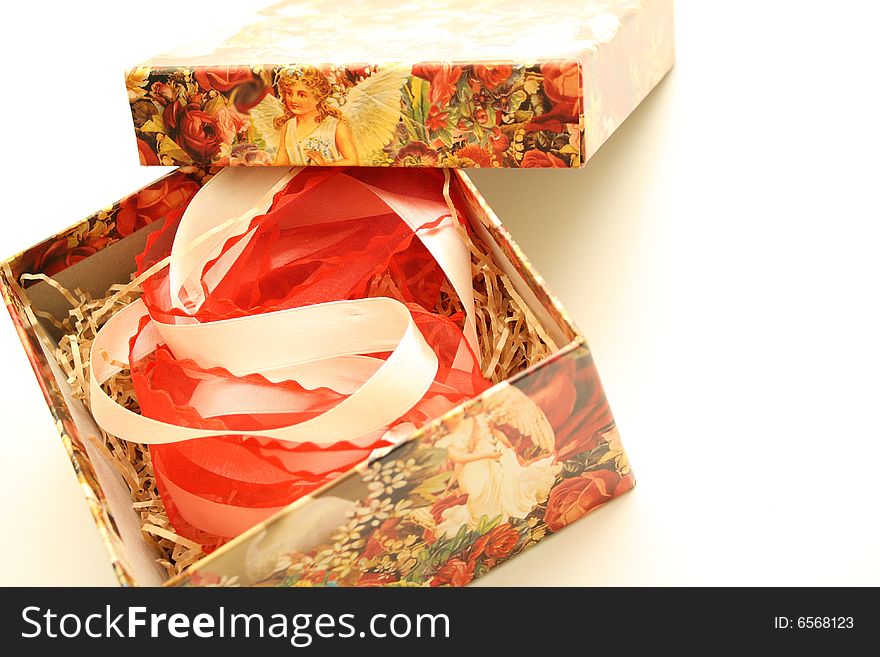 Against the backdrop of gift box with a beautiful figure and the red and white ribbon. Against the backdrop of gift box with a beautiful figure and the red and white ribbon