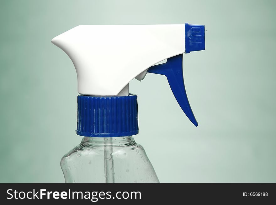 Cleaning products isolated against a green background