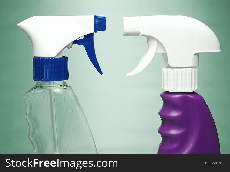 Cleaning products isolated against a green background