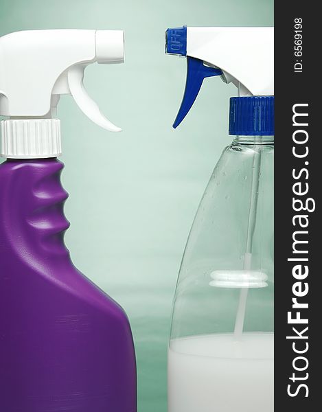 Cleaning products isolated against a green background