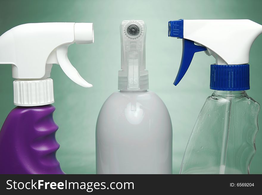 Cleaning products isolated against a green background