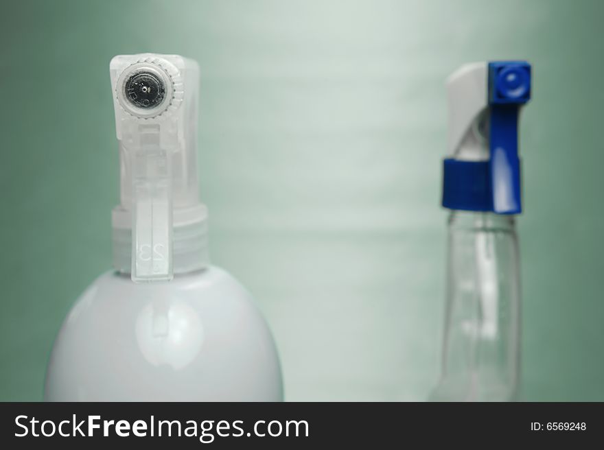 Cleaning products isolated against a green background