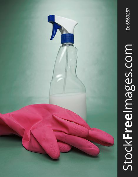 Cleaning products isolated against a green background