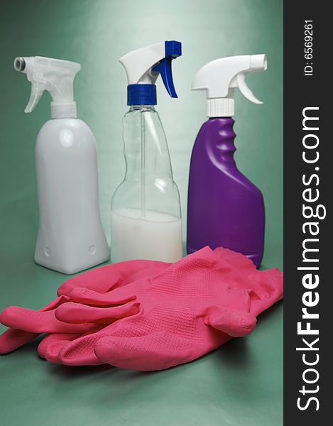 Cleaning products isolated against a green background