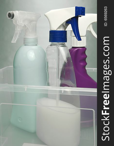 Cleaning products isolated against a green background