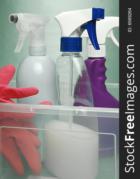 Cleaning products isolated against a green background