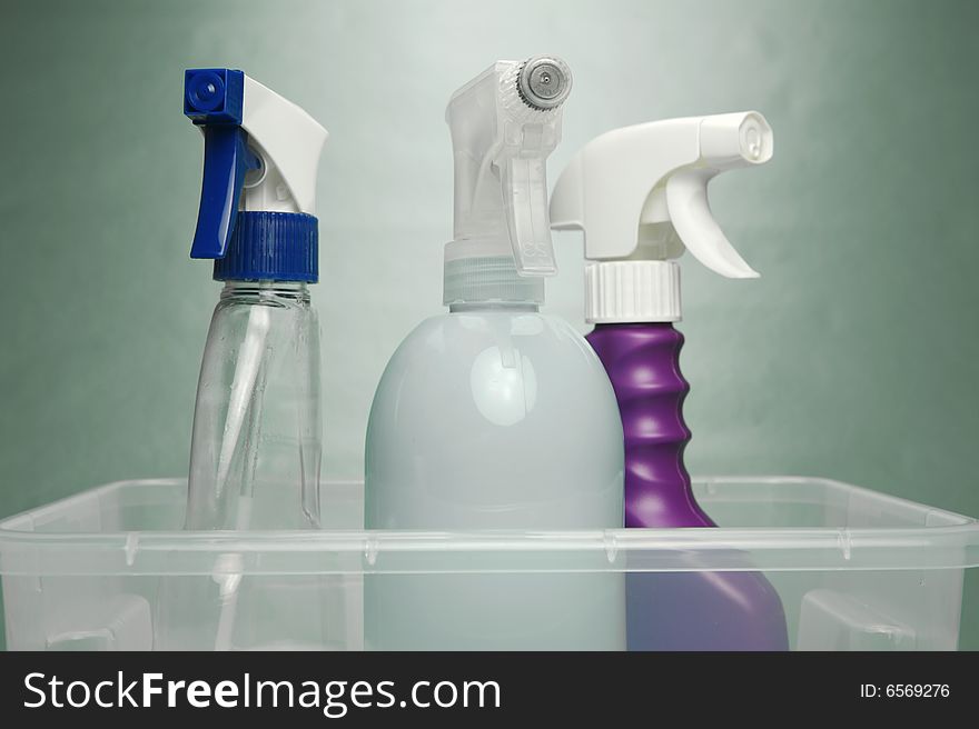 Cleaning products isolated against a green background