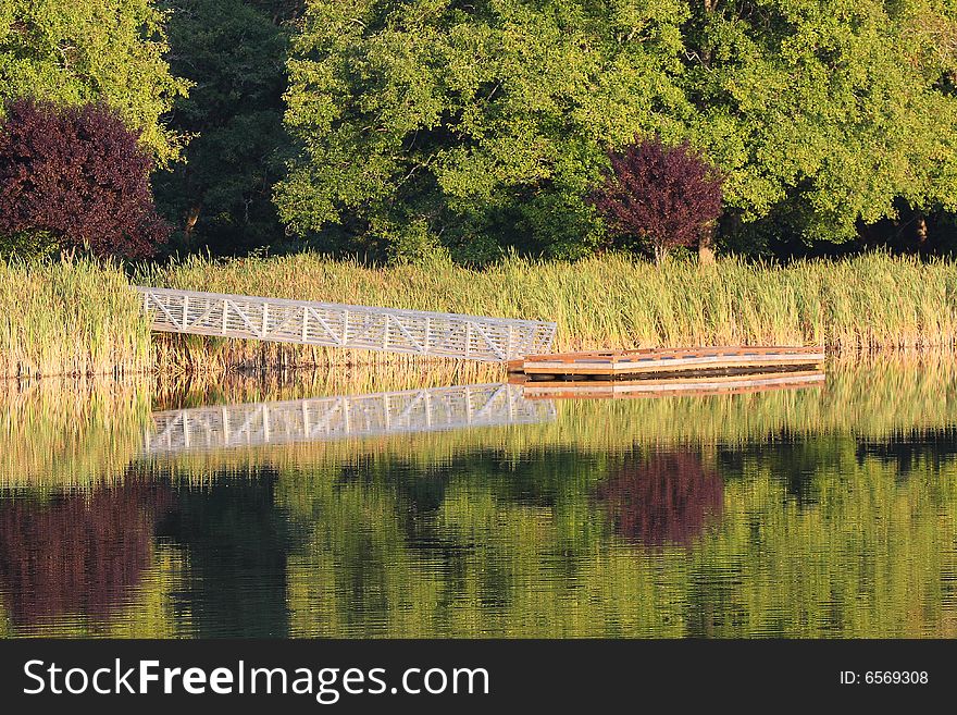 Summertime reflections on the bridge to the fishing dock