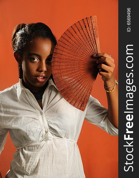 Portrait of trendy african fashion girl with fan. Portrait of trendy african fashion girl with fan