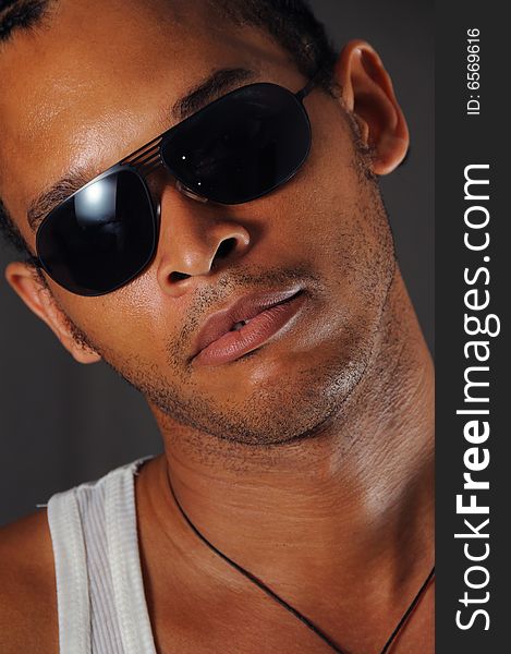 Portrait of young trendy african man with sunglasses