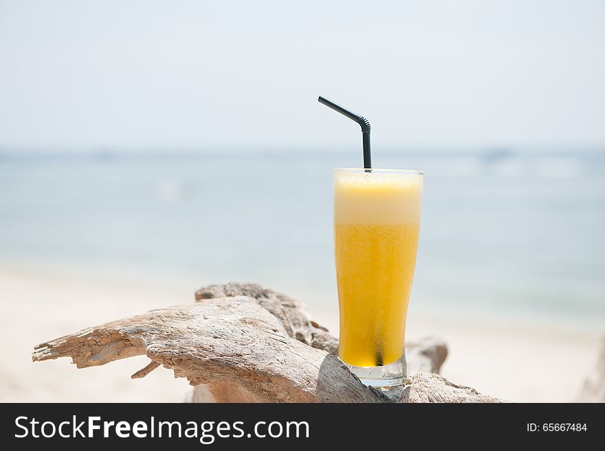 Stock picture of fresh pineapple juice on the beach