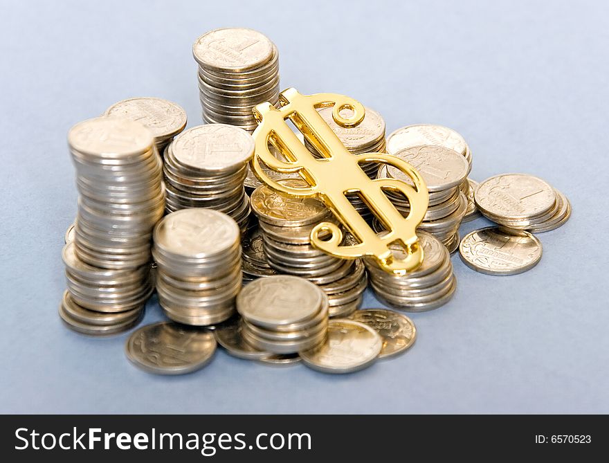 Small silver coins with golden dollar sign. Small silver coins with golden dollar sign