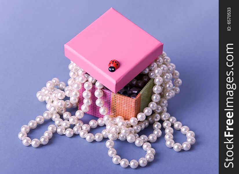 Small pink box with white pearl beads. Small pink box with white pearl beads